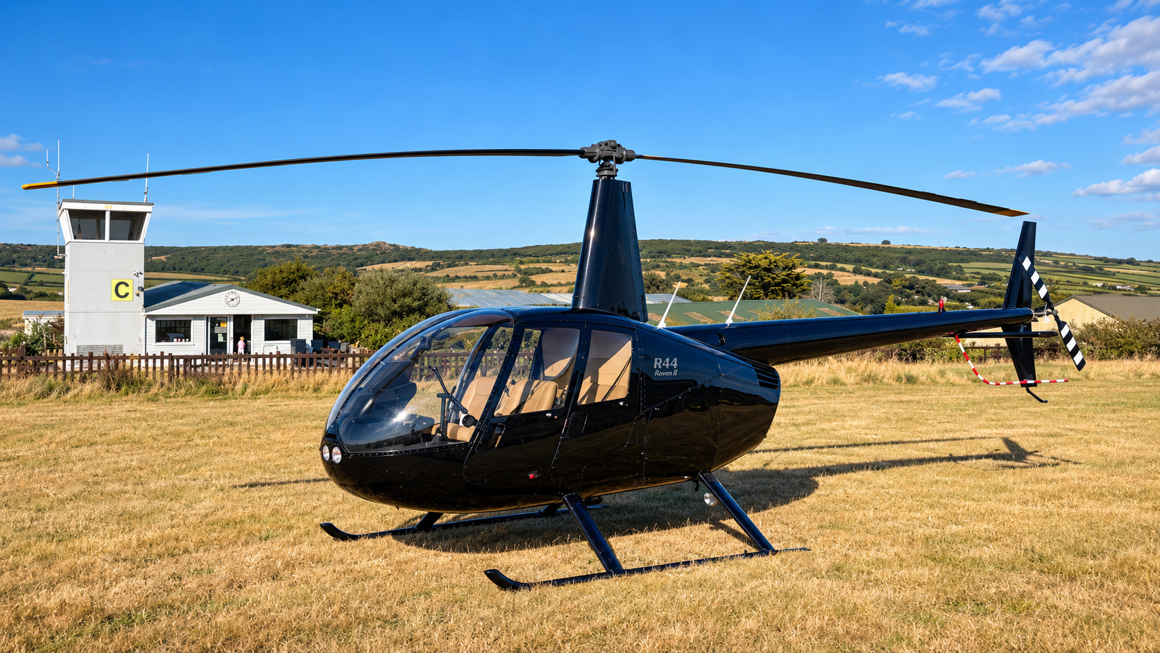Robinson R44 Raven II helicopter at an airfield